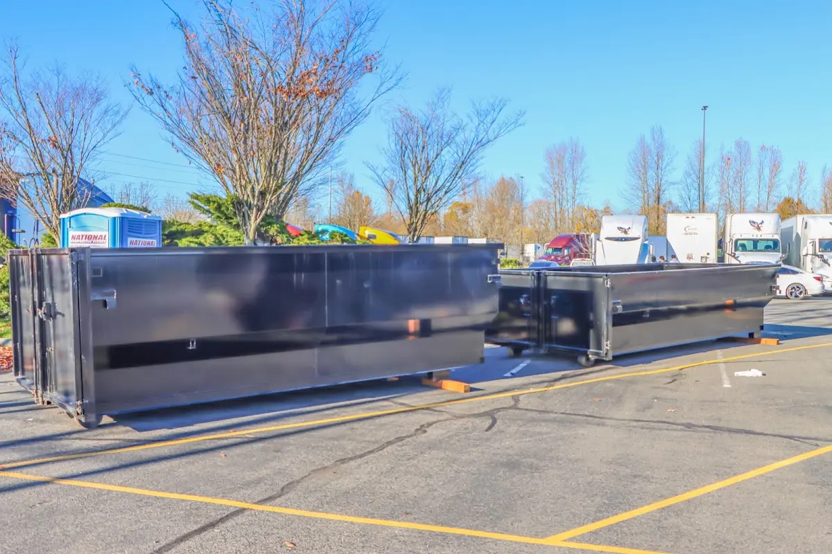 Professional dumpster rental service with roll-off container on residential driveway in Albert Lea